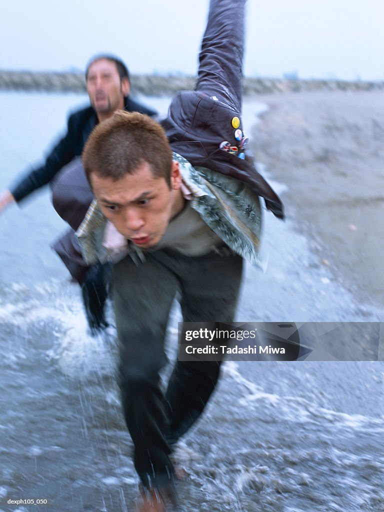 Two men in a chase on beach