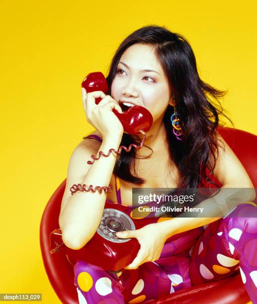 young woman talking our loud at handset - tied to chair stock pictures, royalty-free photos & images