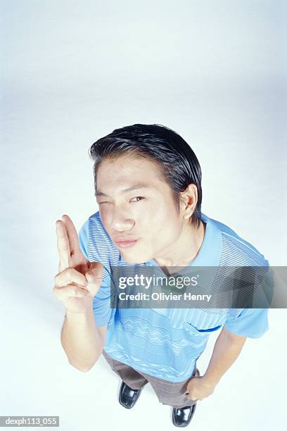 man pointing two fingers, high angle view - henry stockfoto's en -beelden