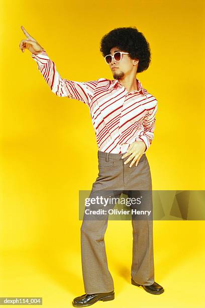 young asian male with afro hair gives the 'staying alive' pose - henry stock pictures, royalty-free photos & images