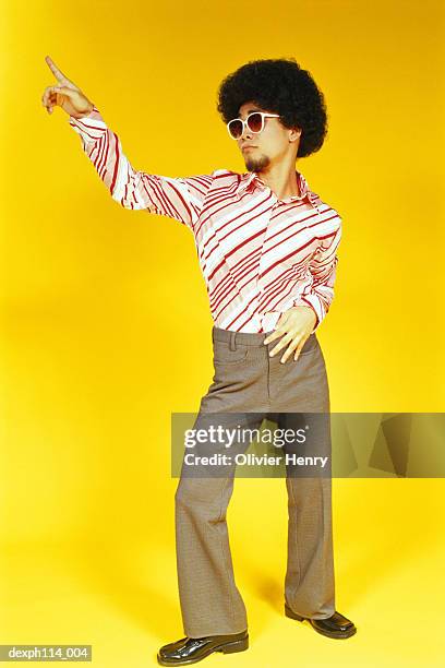 young asian male with afro hair gives the 'staying alive' pose - staying in 個照片及圖片檔