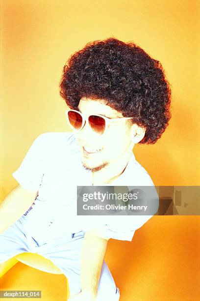 young asian male with afro hair sitting on ball chair - ball chair stock pictures, royalty-free photos & images