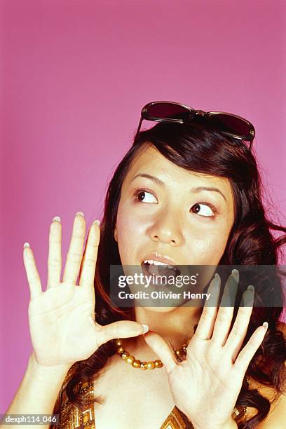 young woman eavesdropping, close-up - henry stockfoto's en -beelden