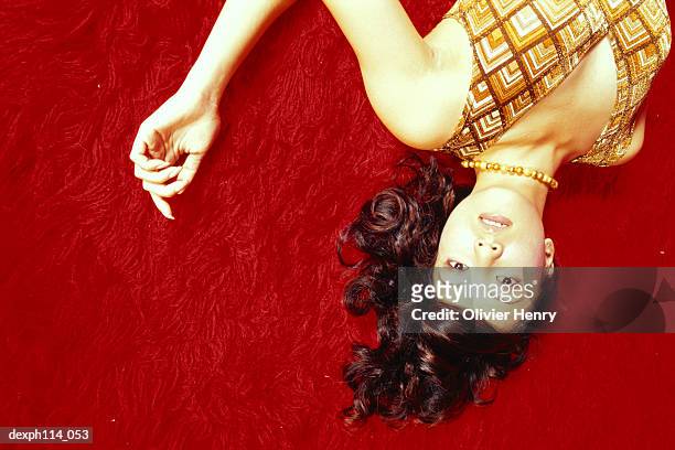 seductive woman lying on carpeted floor, close-up - henry stockfoto's en -beelden