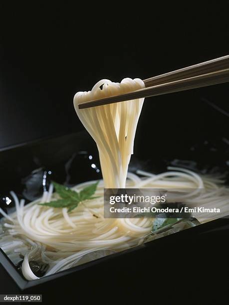 chopsticks picking noodles from bowl - holding chopsticks stock pictures, royalty-free photos & images