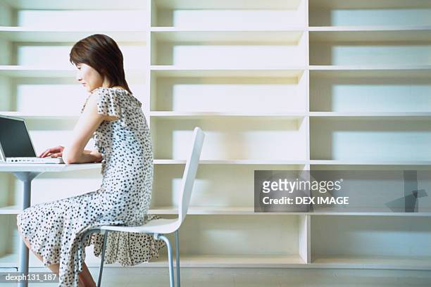 young woman working on a laptop - shirt met ruches stockfoto's en -beelden