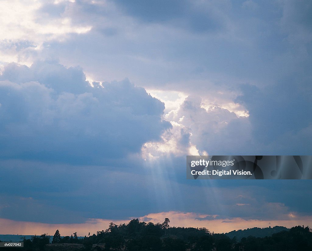 Sun shining through storm clouds