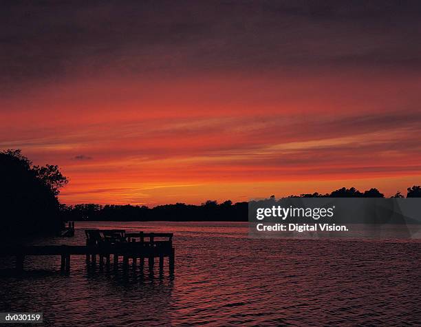 clouds over lake at sunset - cirrostratus stock pictures, royalty-free photos & images