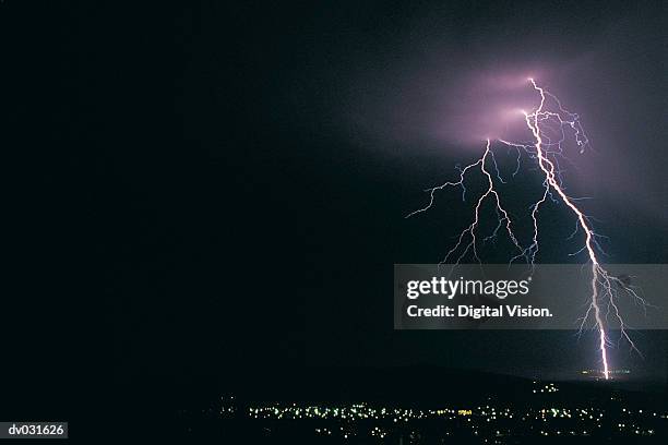 bolt of lightning at night over somerset west, south africa - forked lightning stock pictures, royalty-free photos & images