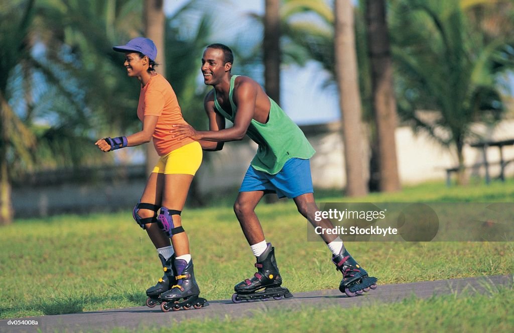 African American couple in-line skating