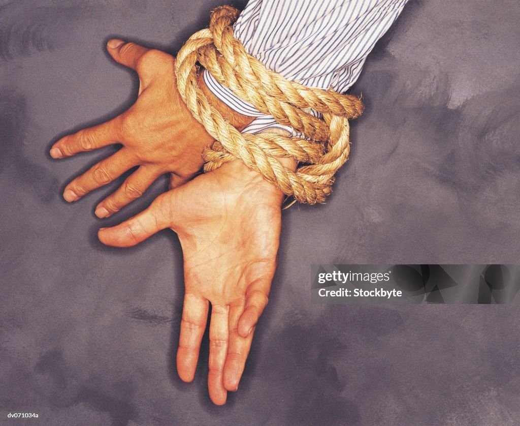 Businessman hands tied
