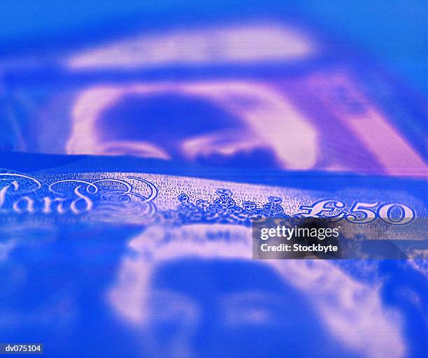 blue blurred banknote - fifty pound note ストックフォトと画像