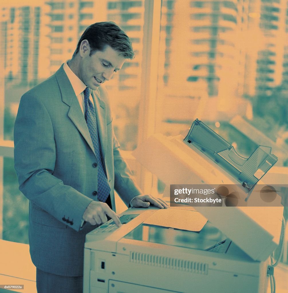 Man operating photocopier