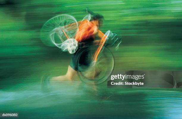 cyclist with bike on shoulder, running - schwenk stock-fotos und bilder