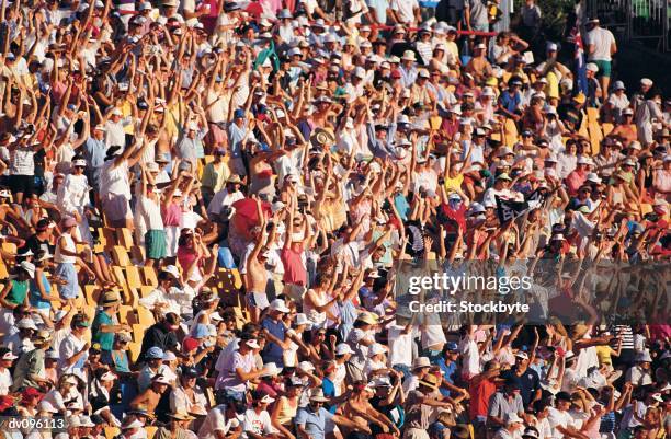 enthusiastic crowd cheering and doing the wave - crowd doing the wave fotografías e imágenes de stock