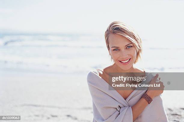 portrait of a young woman by the sea wearing a shawl - bright blue eyes stock pictures, royalty-free photos & images