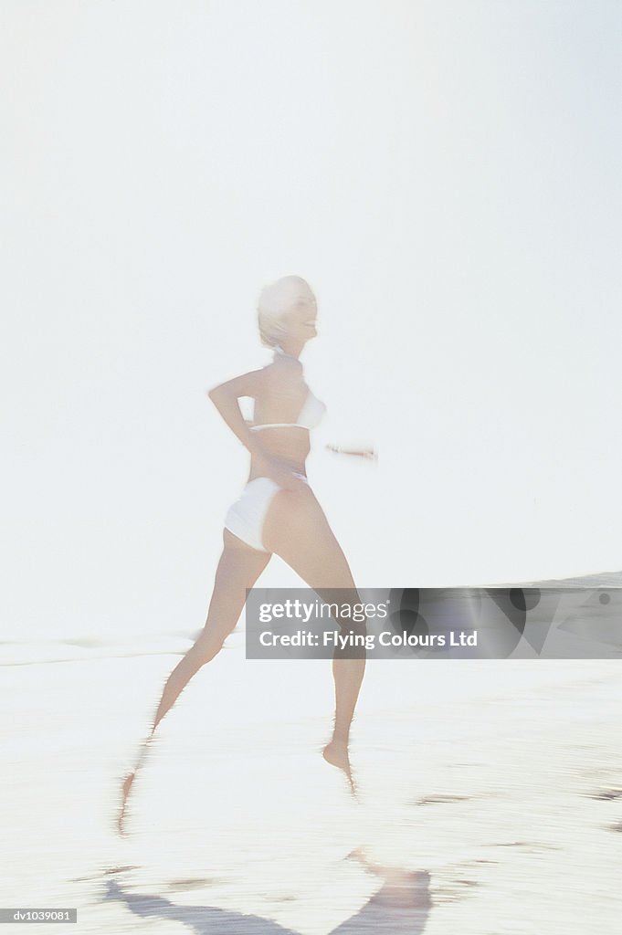 Young Woman Running on the Beach