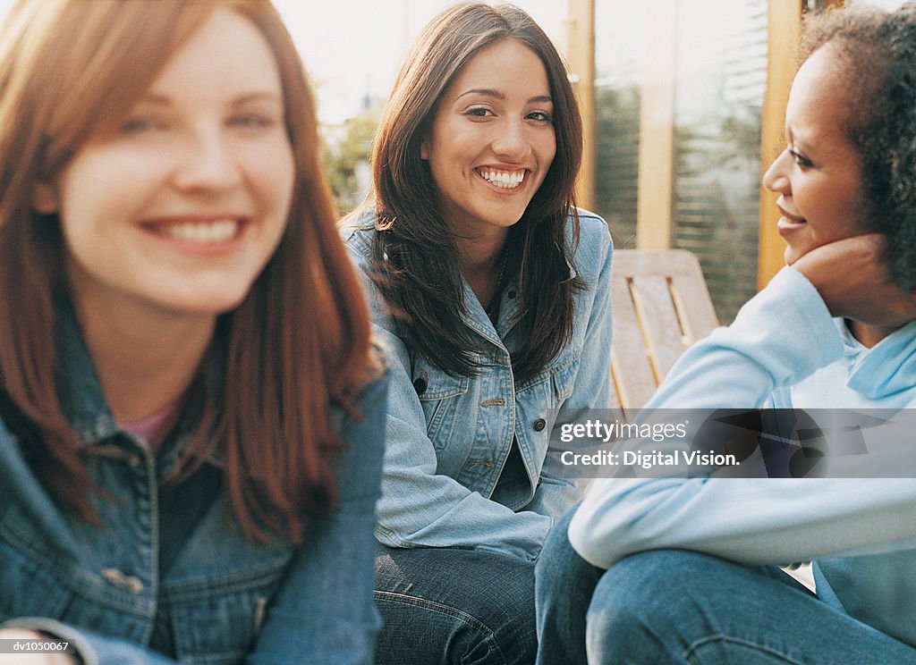 Portrait of a Hispanic Woman in a Garden With Two Friends Next to Her