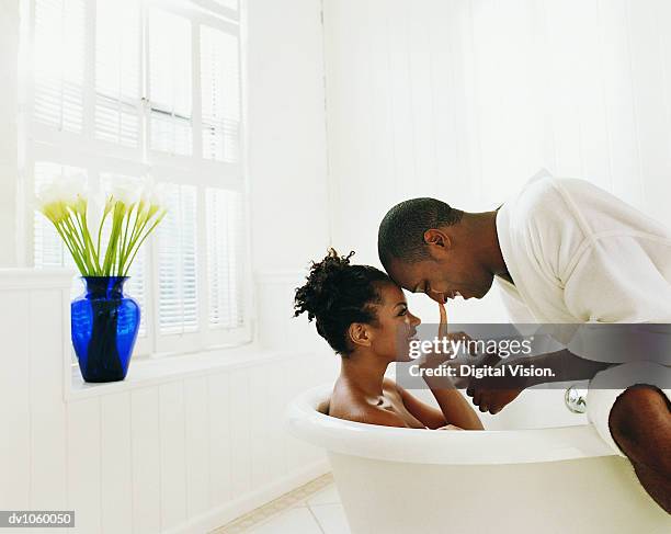 couple sitting in a bathroom - baignoire sur pieds photos et images de collection