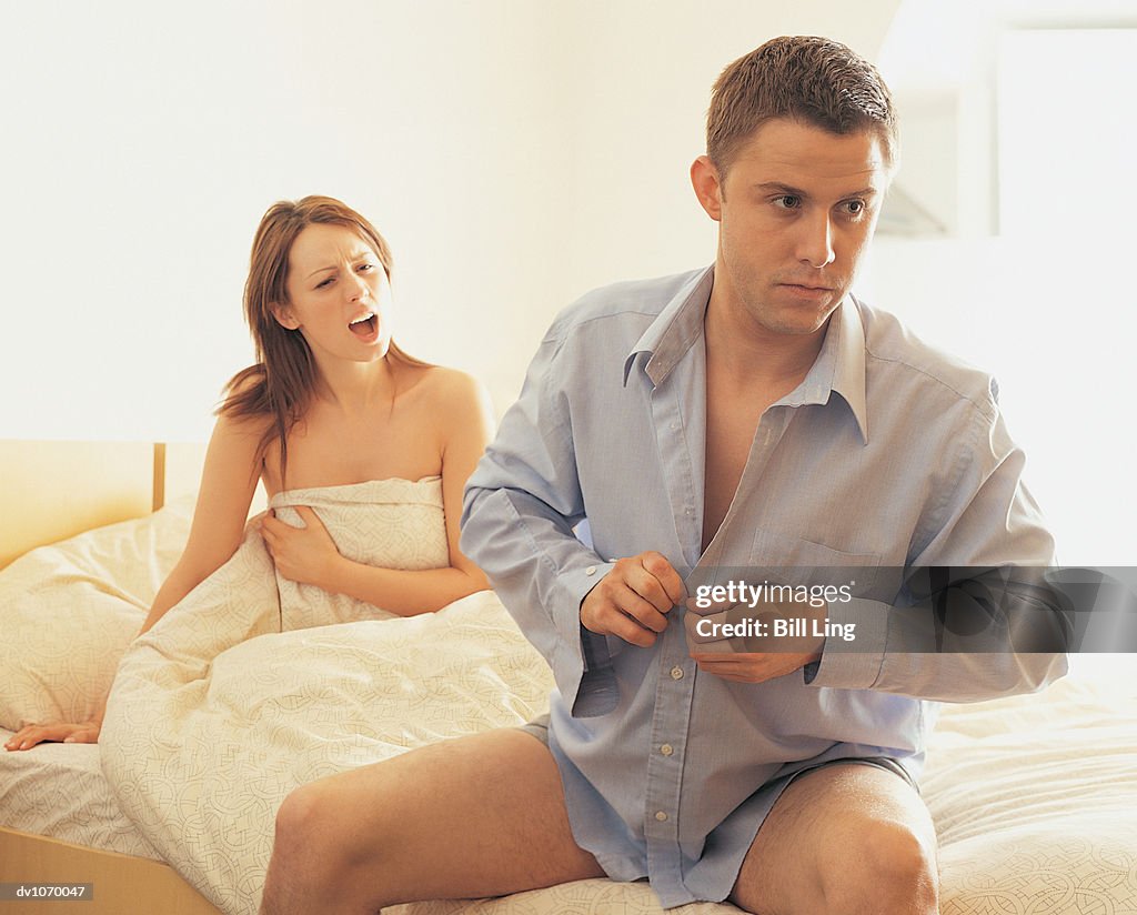 Woman Arguing With Man as He Gets Dressed