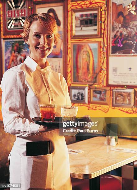 portrait of a waitress holding a tray in a restaurant - waitress booth stock pictures, royalty-free photos & images
