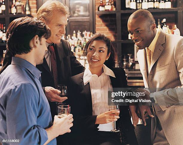 businessmen flirting with a businesswoman in a bar - female with group of males stock pictures, royalty-free photos & images