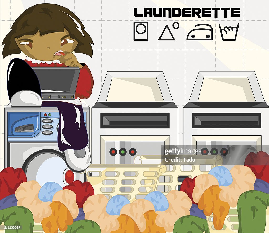 Portrait of a Girl Sitting in a Launderette Using a Laptop Surrounded By Laundry