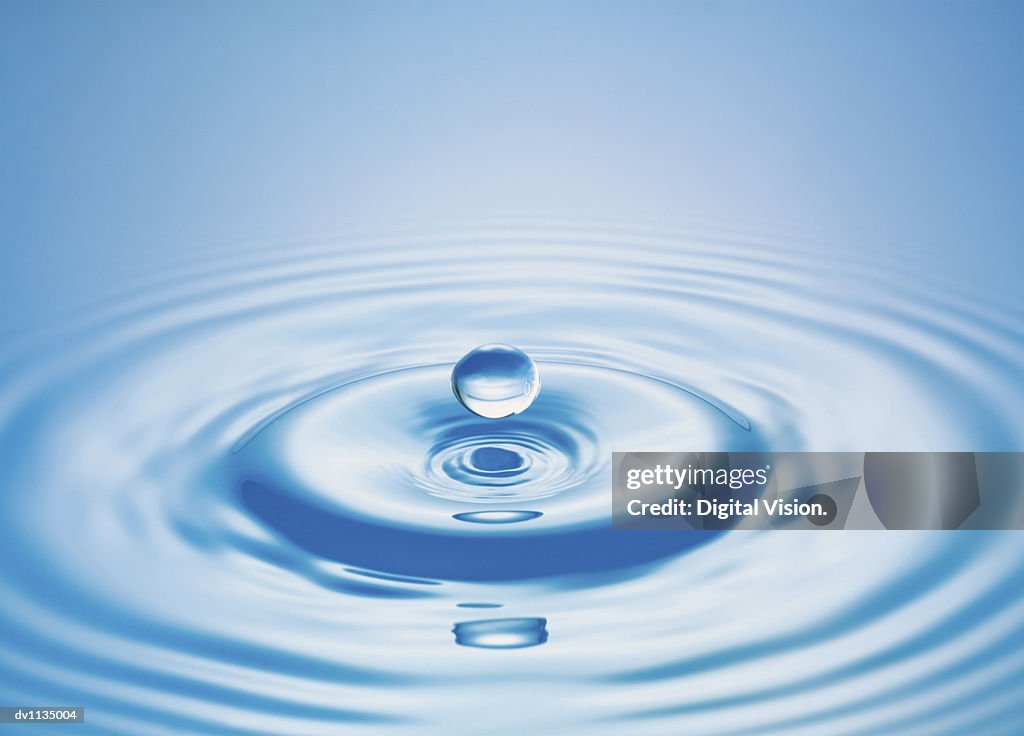 Drop of Liquid Falling Into Water