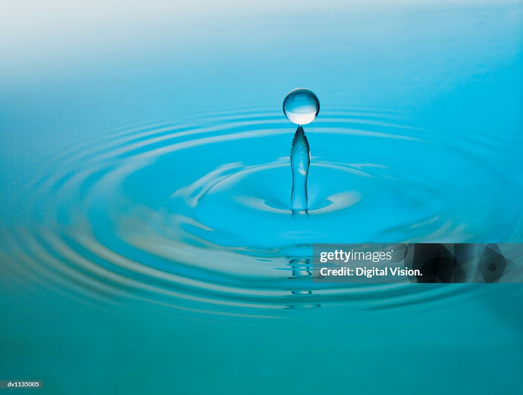 Drop Of Liquid Falling Into Water High-Res Stock Photo - Getty Images
