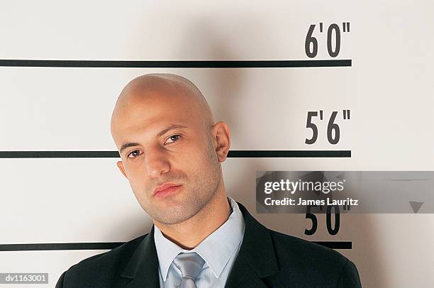 portrait of a tough businessman in a police line-up - lineup fotografías e imágenes de stock