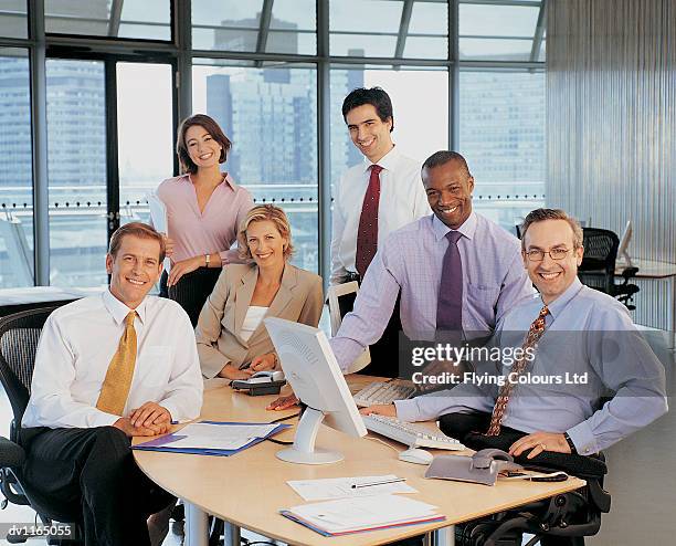 portrait of a six business executives around a desk in their open plan office - open seat godo stock-fotos und bilder