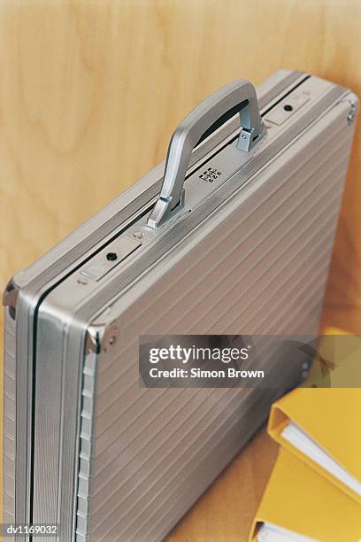 briefcase and two ring binders in an office - binders stockfoto's en -beelden