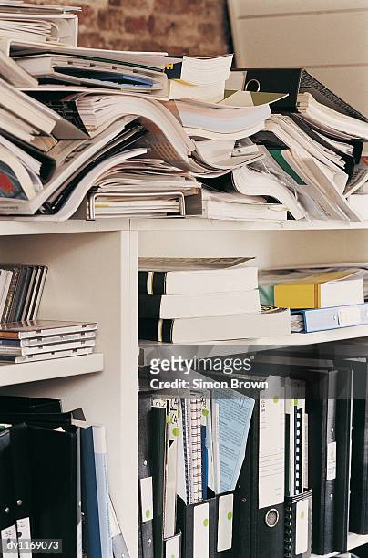 large group of documents, ring binders and books on shelving in an office - binders stockfoto's en -beelden