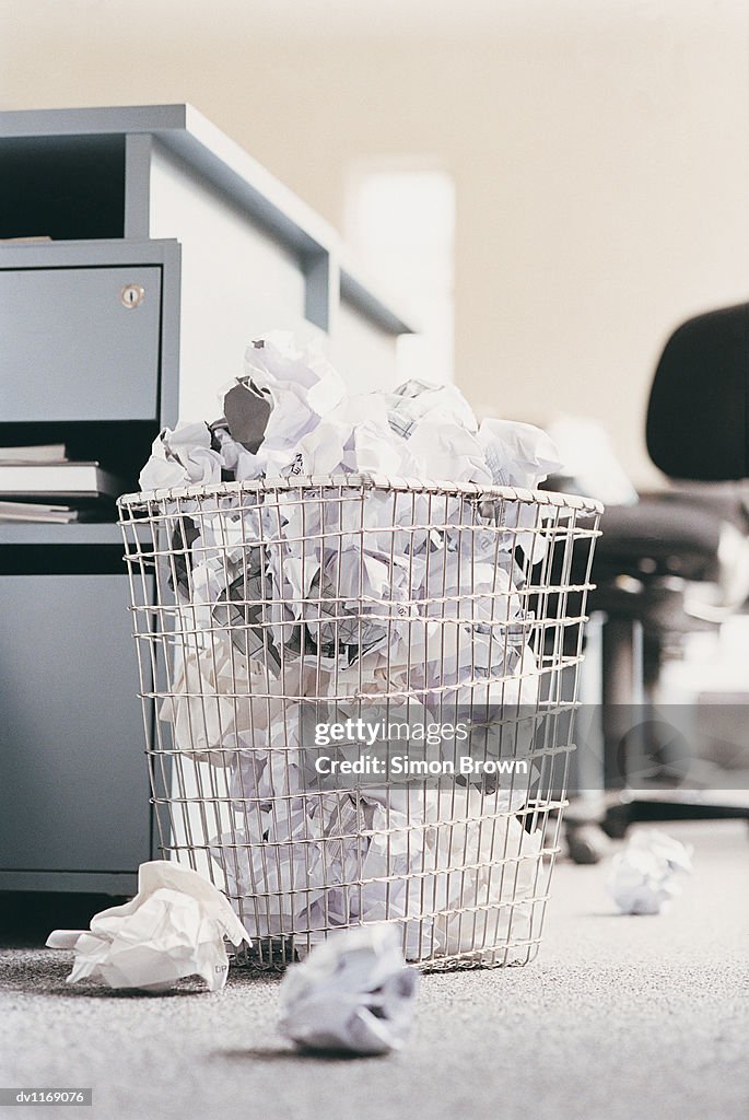 Paper Balls in a Wastepaper Basket in an Office