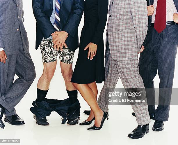 group of businessmen and a businesswoman standing in a line and a businessman with his trousers down - trousers down stock pictures, royalty-free photos & images