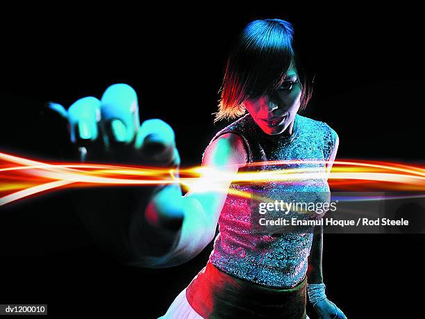 portrait of a young woman reaching out to touch light - gel effect stock pictures, royalty-free photos & images