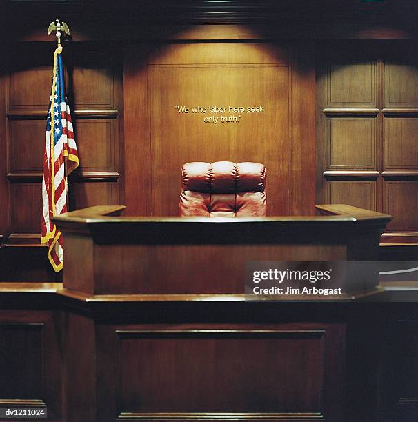 chair in an empty courthouse by the stars and stripes - judging panel stock pictures, royalty-free photos & images