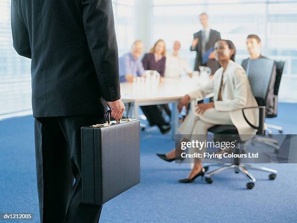 ceo arriving in a conference room of business people - lower employee engagement stock pictures, royalty-free photos & images