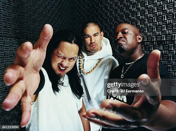 portrait of three rapper standing in a recording studio - rap group stockfoto's en -beelden