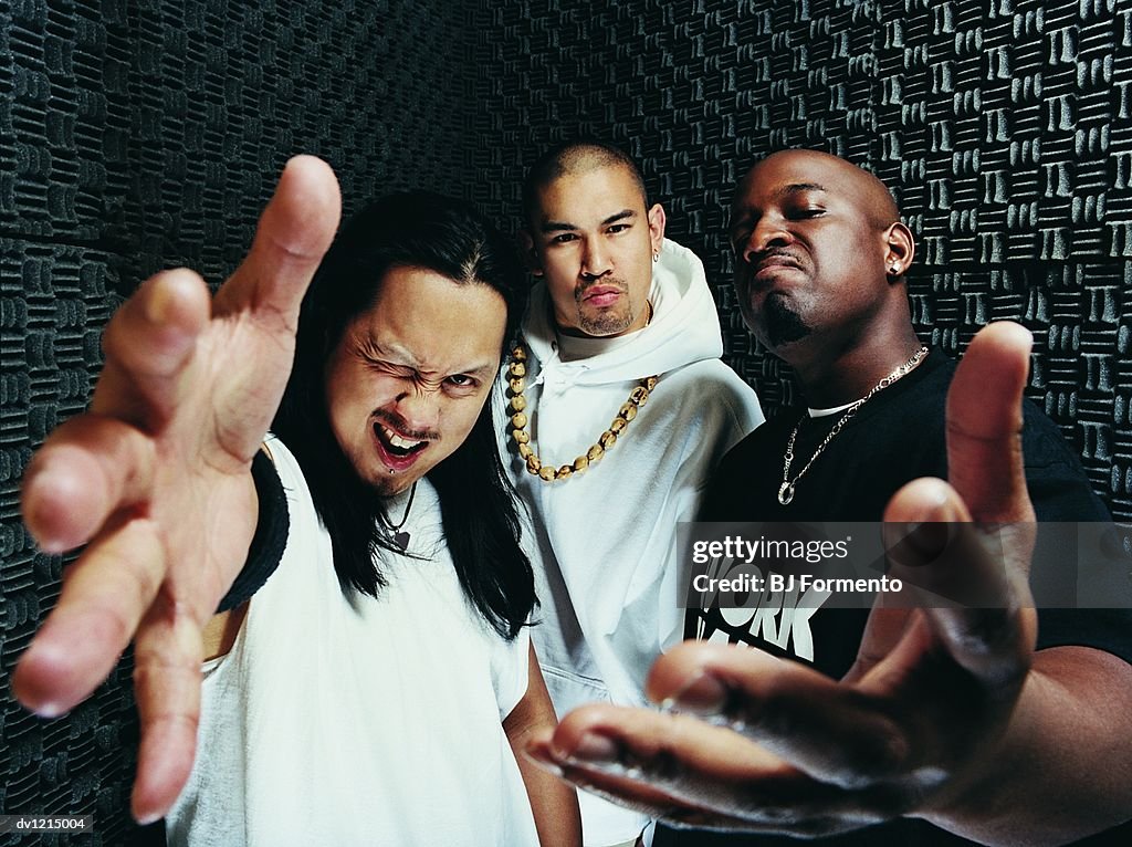 Portrait of Three Rapper Standing in a Recording Studio