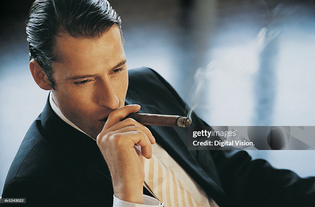 Elevated View of a Young CEO Smoking a Cigar