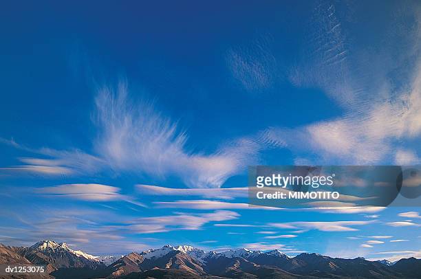 snow covered mountain range under blue sky, denali national park, alaska, usa (colour enhanced) - colour enhanced stock pictures, royalty-free photos & images
