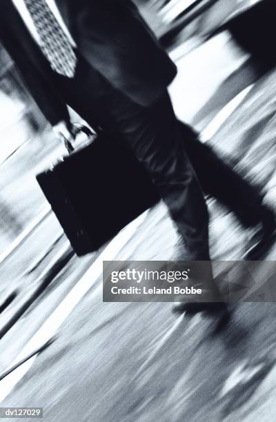 legs of walking businessman - candid black and white corporate stock pictures, royalty-free photos & images