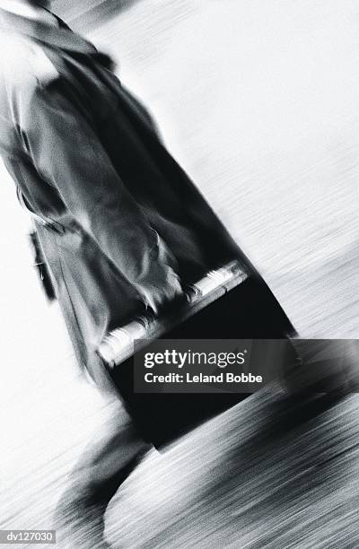 walking businessman in overcoat - candid black and white corporate stock pictures, royalty-free photos & images