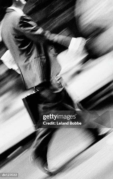 walking businessman with briefcase - leland bobbe foto e immagini stock