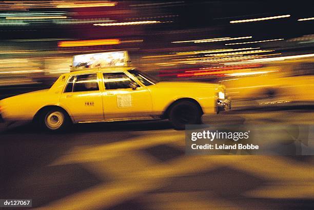 speedy cab on street in evening - speedy ストックフォトと画像