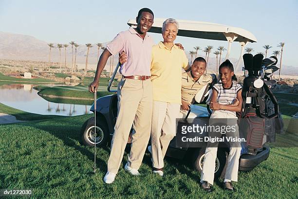 three generational family standing on a golf course - top golf stock pictures, royalty-free photos & images