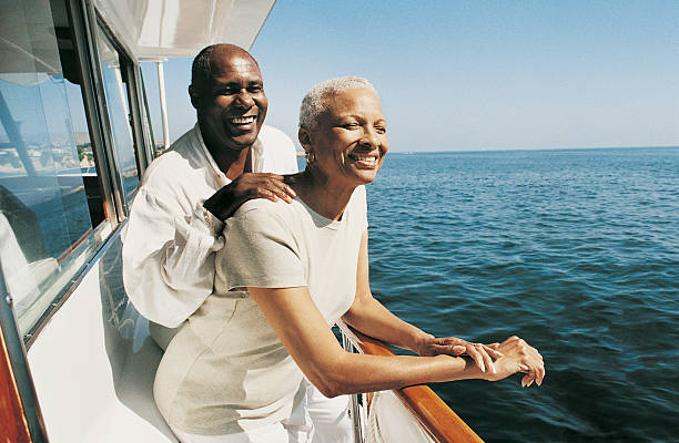 Senior Couple Standing on Deck on a Boat Looking at the View