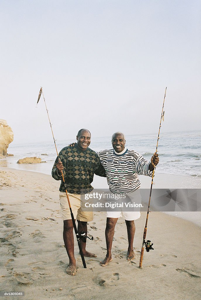 Two Elderly Men Standing On A Beach At The Waters Edge Holding Fishing Rods  High-Res Stock Photo - Getty Images
