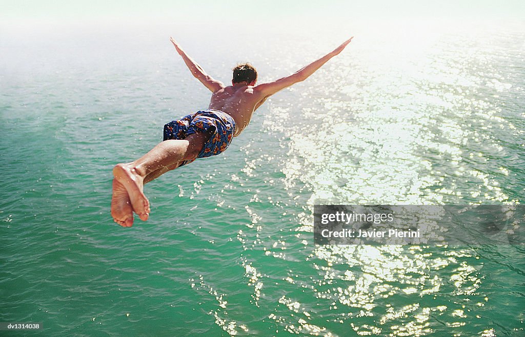 Rear View of a Man Diving into the Sea